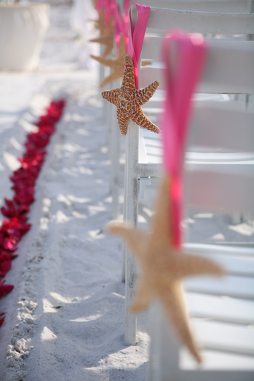 Chair Decorations Large starfish with hot pink ribbon hanging from chairs